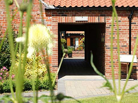 A view through the entrance to our self catering cottages and the courtyard garden.